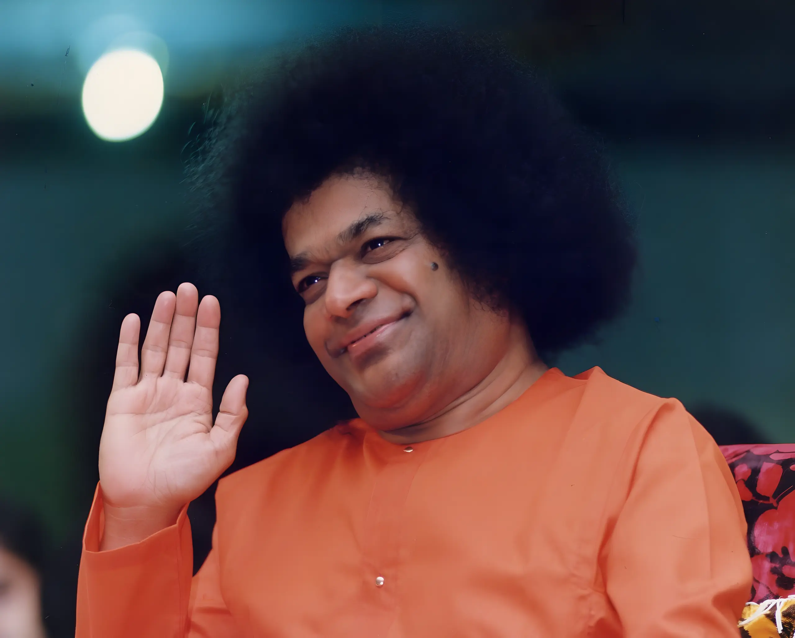 Bhagawan Sri Sathya Sai Baba raising His hand in blessing