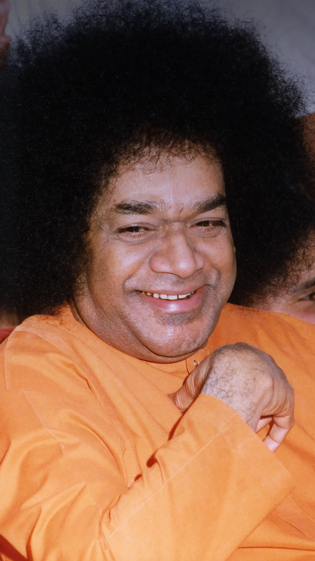 Bhagawan Sri Sathya Sai Baba laughing with joy